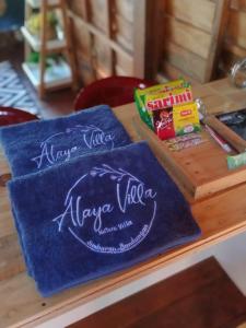 a table with two napkins and some snacks on it at Alaya Villa in Bandungan
