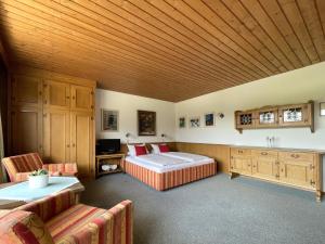 a large bedroom with a bed and a wooden ceiling at Chalet Cristall in Leutasch