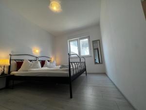 a bedroom with a bed and a window at Apartments PETRUSIC in Rab