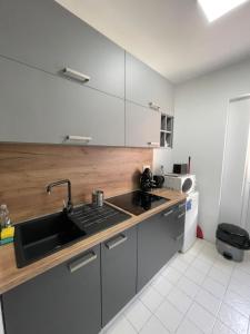 a kitchen with a sink and a counter top at Viczentrum in Siófok