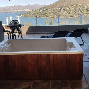 a bath tub sitting on top of a house at El Shadai Guest House & Spa Hartbeespoort in Hartbeespoort