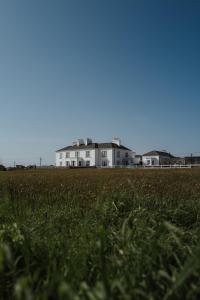 a white house in the middle of a field at Armada House in Spanish Point