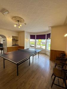 a large room with a ping pong table in it at Mackay's Spa Lodge Hotel in Strathpeffer