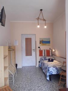 a small bedroom with a bed and a door at B&B Jamba self ceck in in Alghero