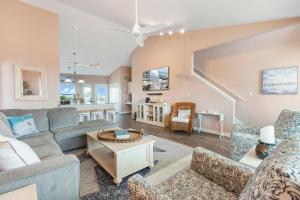 a living room with a couch and a table at Gratitude Island in Navarre