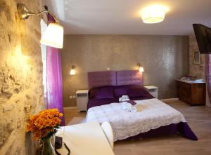 a bedroom with a bed with a stuffed animal on it at Bed & Breakfast Vila Baguc in Split