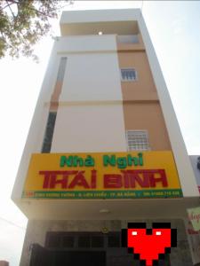 a building with a sign on the side of it at THAI BINH MOTEL in Danang