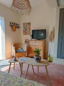 a living room with a tv and a table at Dolce Vita en Provence in Châteaurenard