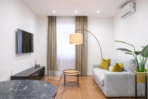 a living room with a couch and a table at Aroma Apartment, Maschio Angioino-Porto Di Napoli in Naples