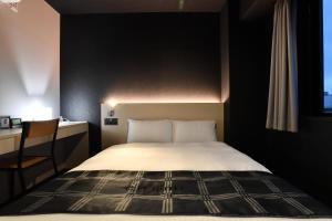 Postel nebo postele na pokoji v ubytování FL Hotel Dotonbori