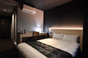 Postel nebo postele na pokoji v ubytování FL Hotel Dotonbori