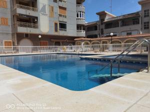 a swimming pool with a slide in front of a building at Holiday Apartment in Torrevieja
