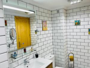 メリダにあるApartamentos MERIDA LUDICA parking gratis en el centro de la ciudadの洗面台、鏡、トイレ付きのバスルーム +27枚の写真