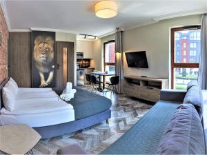 a bedroom with a bed and a lion painting on the wall at Zefiro Chmielna in Gdańsk