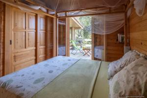 a bedroom with a large bed in a house at Les Terrasses de Scaglioli in Villanova