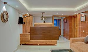 a living room with wooden furniture and a couch at Treebo Trend Lucent The Homely Stay in Chikmagalūr