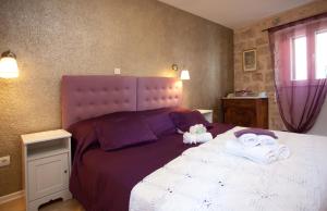 a bedroom with a large bed with towels on it at Bed & Breakfast Vila Baguc in Split