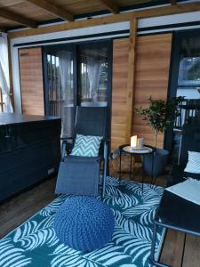 a screened porch with a couch and chairs and a table at Mobile Home Aurora Selce in Selce