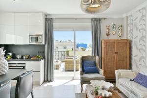 a kitchen and living room with a couch and a table at Luxury Penthouse Mogan VII in Puerto de Mogán