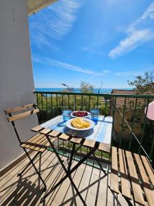 a table with a plate of food on a balcony at Casa Marina in Ortona