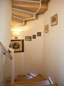 a staircase with wooden ceilings and pictures on the wall at Bed & Breakfast Vila Baguc in Split