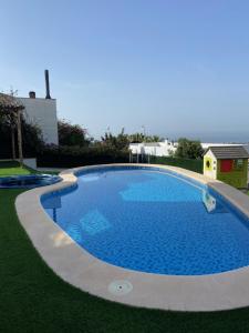 a large blue swimming pool in a yard at Casa Mediterránea in Vilassar de Dalt