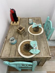 a wooden table with two plates of food on it at Casa Mediterránea in Vilassar de Dalt