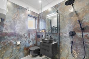 a bathroom with a shower and a toilet and a sink at Apartments Villa Verde in Novigrad Istria +38 photos