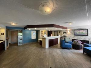a lobby of a hospital with blue chairs and a counter at Comfort Inn in Cornwall