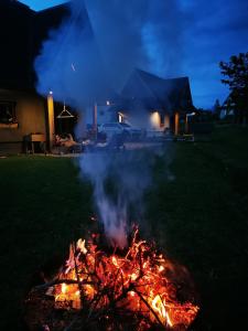 a fire pit in a yard at night at Heidi in Zakopane