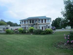 a large house with a yard with a grass field at Bayview Inn Orillia in Orillia