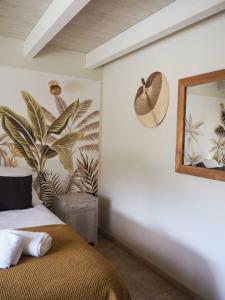 a bedroom with a bed with a mirror and a plant at songes d été2 in Bonifacio