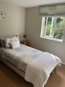 a bedroom with a bed and a window at Home in Midsomer Norton, near Bath & Bristol in Midsomer Norton +13 photos