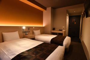 Postel nebo postele na pokoji v ubytování FL Hotel Dotonbori