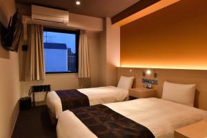 Postel nebo postele na pokoji v ubytování FL Hotel Dotonbori
