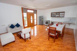 a large living room with a table and chairs at Blue Marlin Hotel in Puerto Baquerizo Moreno