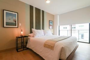 Postel nebo postele na pokoji v ubytování Amazing 2BR Duplex in Miraflores