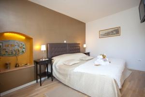 a bedroom with a bed with a teddy bear on it at Bed & Breakfast Vila Baguc in Split