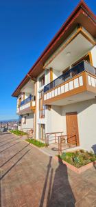 a large white building with a balcony and a porch at RizeKonak Luxury Villa Private Garden Ac Sea View in Rize