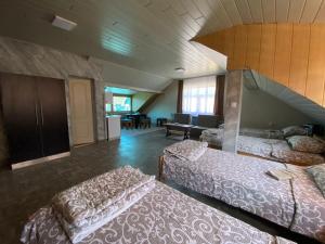 a room with two beds and a living room at Vista Point Apartment in Bajina Bašta