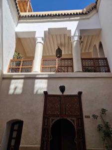 une entrée dans un bâtiment avec un portail et un toit dans l'établissement DAR AL AMAL, à Marrakech