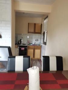 a kitchen with a table and two chairs in a room at Relax house in Visoko