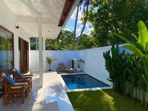 a patio with a swimming pool in a house at Balian Hideaway in Balian