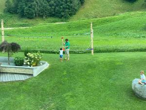 a man and a young child playing a game in a yard at Laudinella - Apart in See