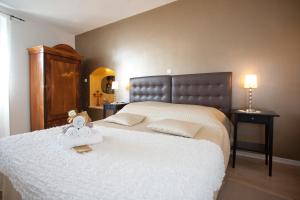 a bedroom with a large bed with a white blanket at Bed & Breakfast Vila Baguc in Split