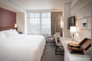 a hotel room with a bed and a desk at The Elizabeth Hotel, Autograph Collection in Fort Collins