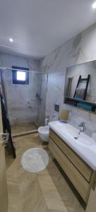 a bathroom with a tub and a sink and a toilet at theasis1 in Neos Marmaras