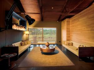 a living room with two couches and a table at Lavandeira Douro Nature & Wellness in Ancede