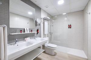 a bathroom with a sink and a toilet and a shower at Tigotan Lovers & Friends Playa de las Americas - Adults Only (+18) in Playa de las Americas