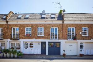 a red brick house with two garages at The Holland Park Crib - Classy 2BDR House in London